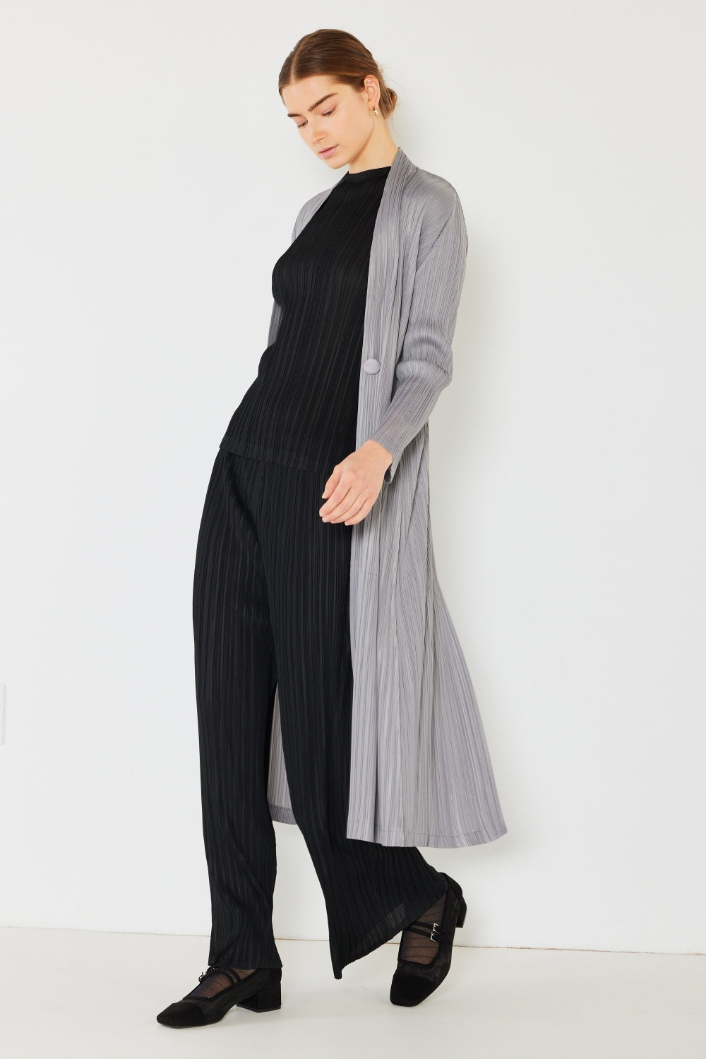 The Pleated Long Sleeve Cardigan is a versatile and chic layering piece for your wardrobe. With its pleated detailing and long sleeves, this cardigan offers a stylish and sophisticated look. The pleats add texture and visual interest to the classic cardigan design. 