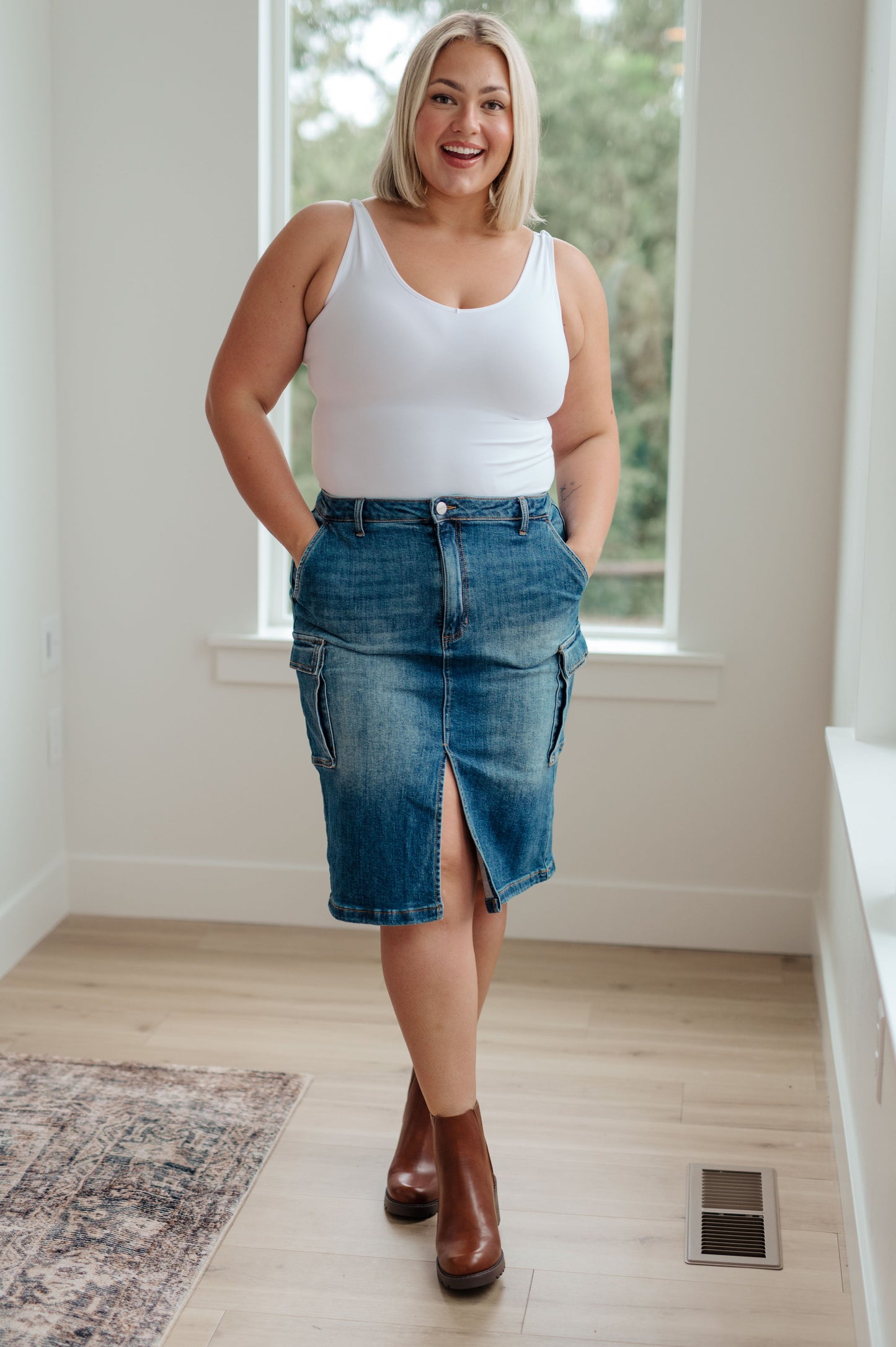 This stylish Always Be There Cargo Denim Skirt is the perfect piece for everyday wear. It's crafted with stretchy medium wash denim for a comfortable fit and extra movement, and features a front slit and cargo pockets for a more dynamic look. Look great and put your most fashionable foot forward! S - 3X