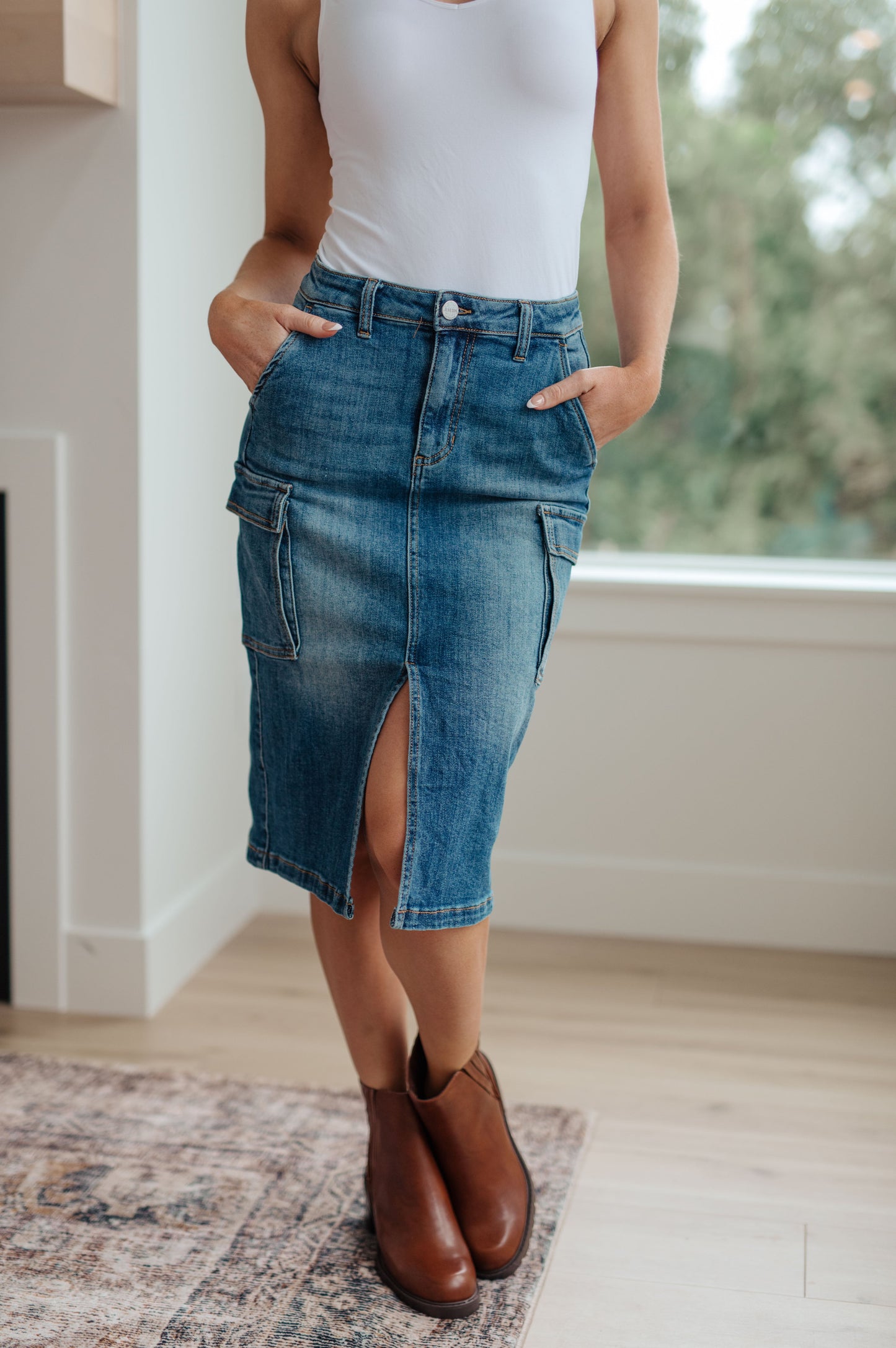 This stylish Always Be There Cargo Denim Skirt is the perfect piece for everyday wear. It's crafted with stretchy medium wash denim for a comfortable fit and extra movement, and features a front slit and cargo pockets for a more dynamic look. Look great and put your most fashionable foot forward! S - 3X