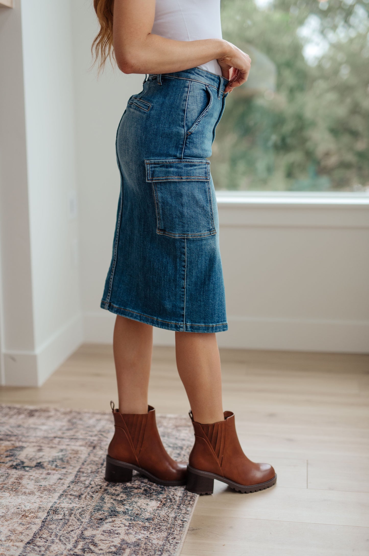 This stylish Always Be There Cargo Denim Skirt is the perfect piece for everyday wear. It's crafted with stretchy medium wash denim for a comfortable fit and extra movement, and features a front slit and cargo pockets for a more dynamic look. Look great and put your most fashionable foot forward! S - 3X