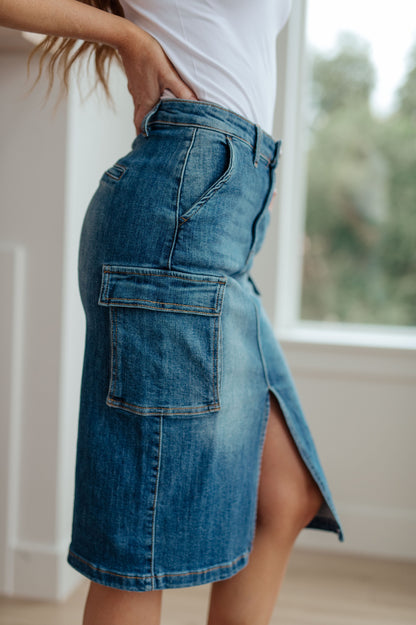 This stylish Always Be There Cargo Denim Skirt is the perfect piece for everyday wear. It's crafted with stretchy medium wash denim for a comfortable fit and extra movement, and features a front slit and cargo pockets for a more dynamic look. Look great and put your most fashionable foot forward! S - 3X