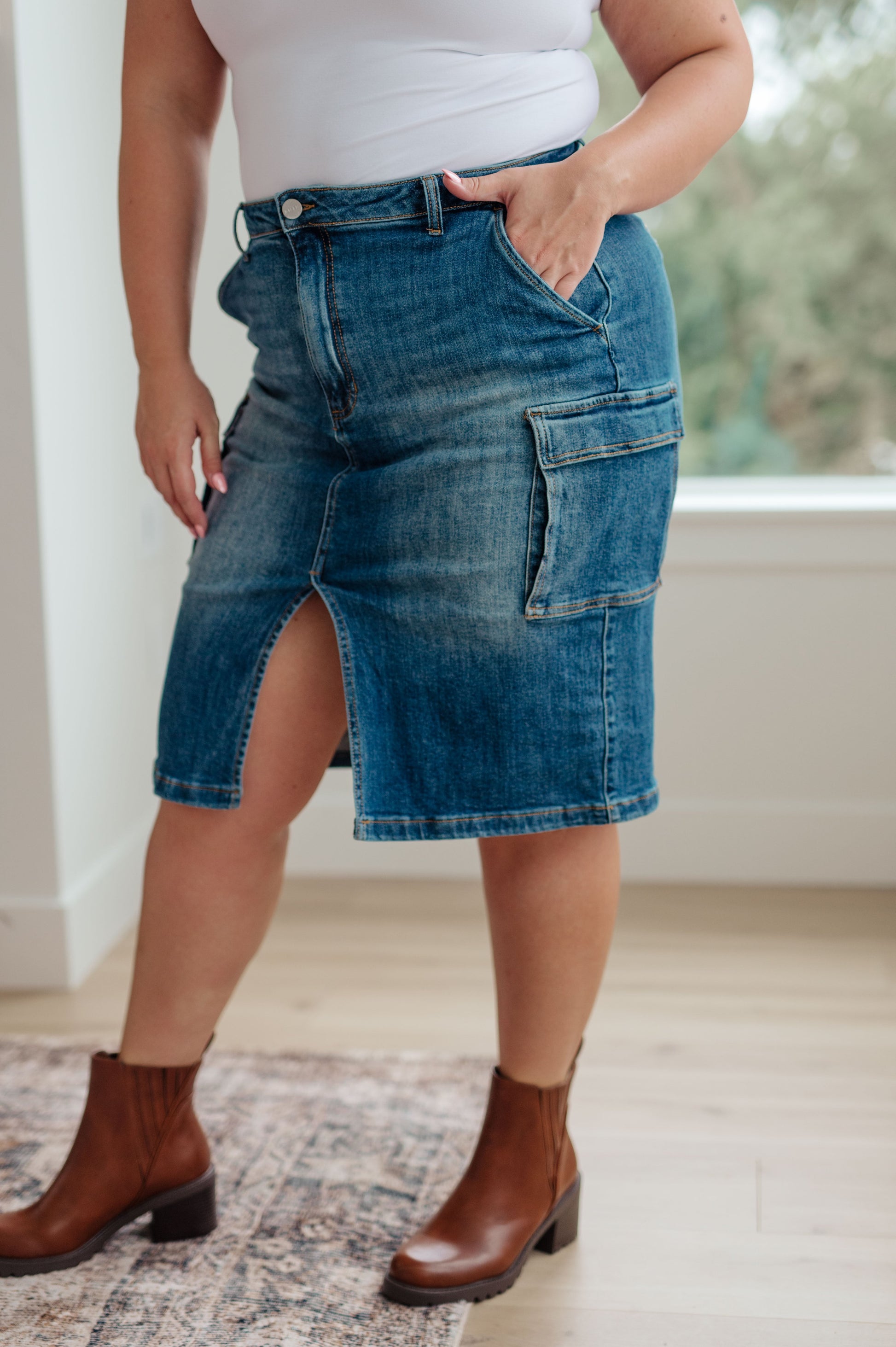 This stylish Always Be There Cargo Denim Skirt is the perfect piece for everyday wear. It's crafted with stretchy medium wash denim for a comfortable fit and extra movement, and features a front slit and cargo pockets for a more dynamic look. Look great and put your most fashionable foot forward! S - 3X