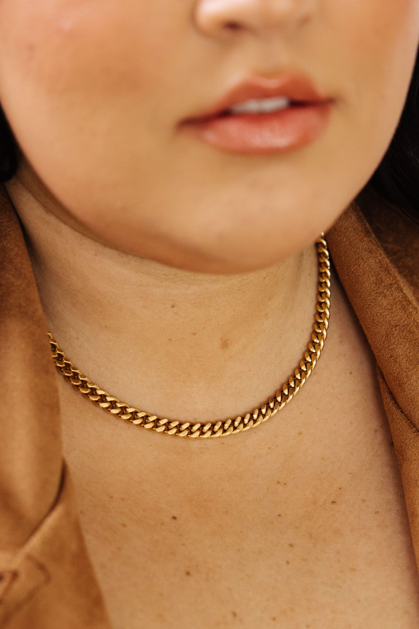 Introducing the Chain Reaction Gold Plated Choker! Crafted with 18K gold plated stainless steel and a classic choker design, this necklace is a beautiful and timeless addition to any jewelry collection. The Cuban link chain ensures durability while shining for many years to come.  18K gold plated stainless steel means you can wear this piece to the beach, the pool, or even working out without worrying over tarnishing, green marks, or skin irritation.