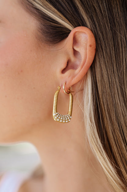 Add an elegant touch to your look with these beautiful Drop Pearl Accent Earrings. Boasting an 18K gold rectangular drop hoop design with a pearl trim for classic appeal, they add a stylish sparkle to any outfit.  18k gold plated stainless steel means you can wear this piece to the beach, the pool, or even working out without worrying over tarnishing, green marks, or skin irritation.