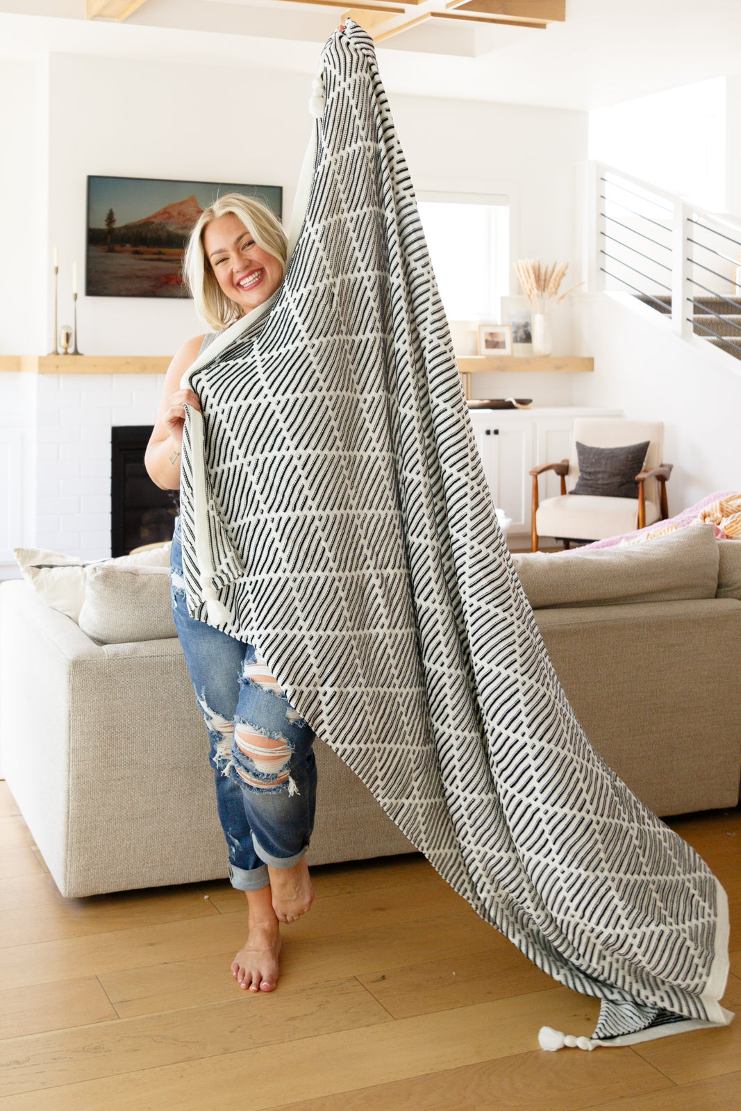 Elevate your home decor this fall with these soft and trendy tassel blankets from Cuddle Culture! Available in a black and white stripe texture with a stunning geometric design and tassel accent on all four corners.