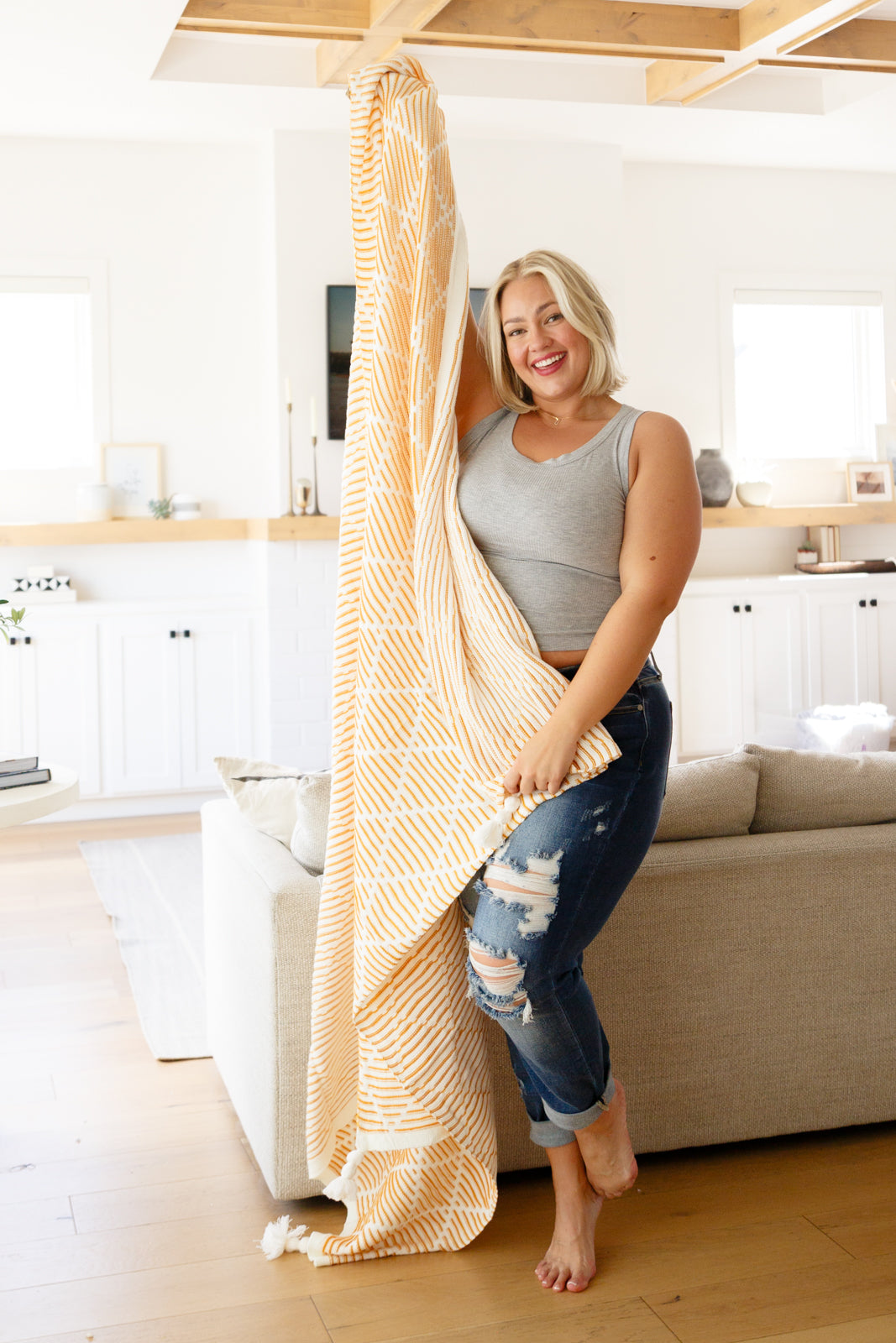 Elevate your home decor this fall with these soft and trendy tassel blankets from Cuddle Culture! Available in a yellow and white stripe texture with a stunning geometric design and tassel accent on all four corners.