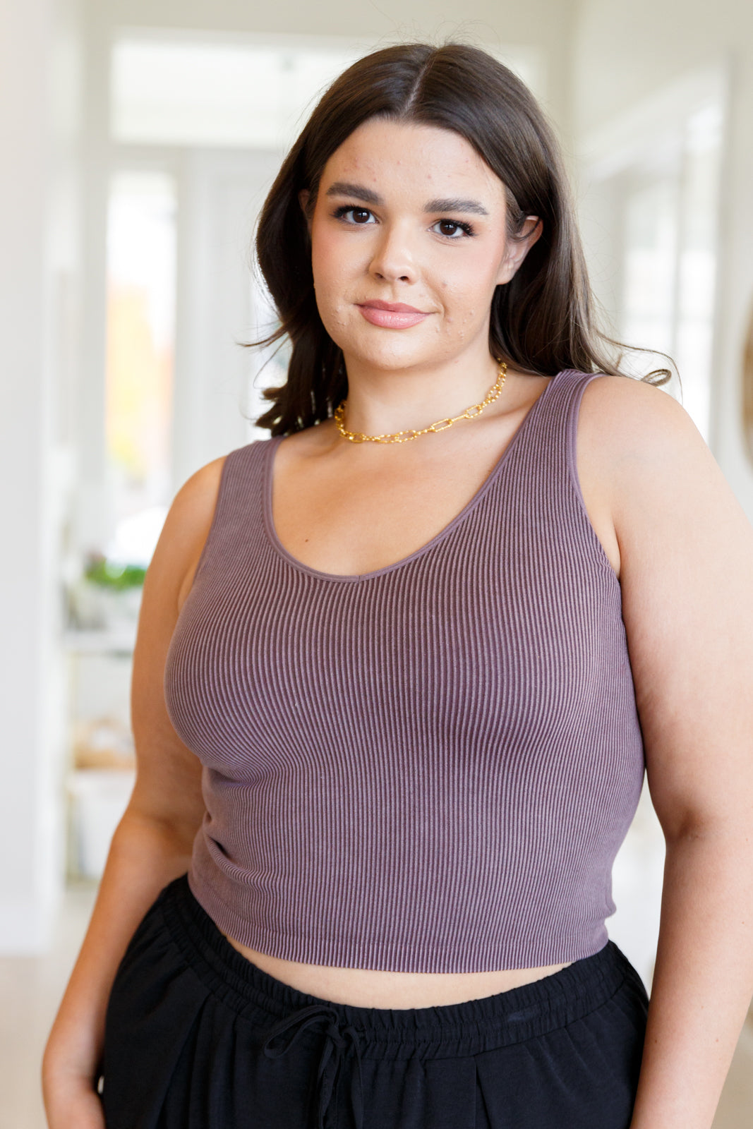 This tank is the perfect combination of function and fashion. Crafted from ribbed fabric with a seamless finish, it offers a flattering, cropped fit that can be customized with your choice of v-neck or scoop neck. Plus, its mineral wash makes it a true stand-out piece.
