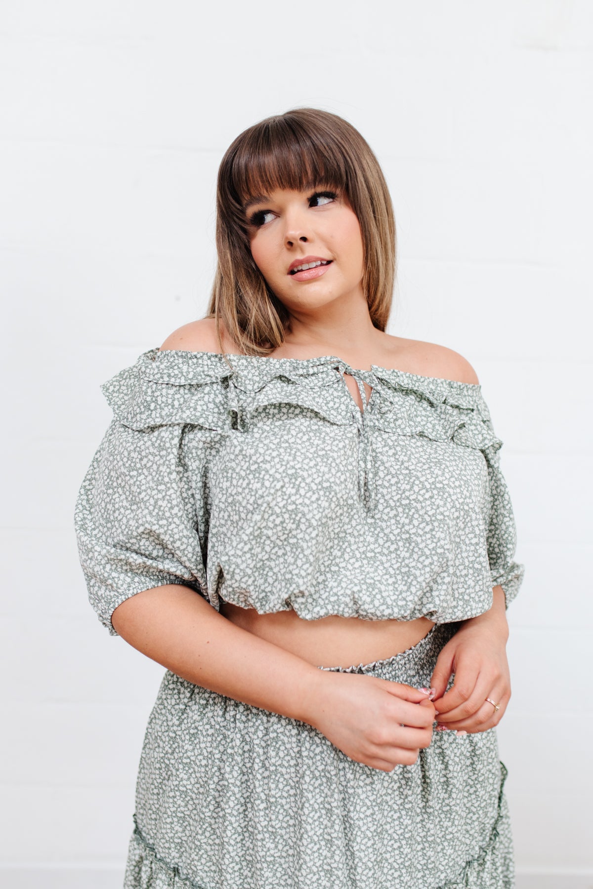 Head to date night in style in the Golden Hour Top! This cute top has all the details that we absolutely love. Featuring a ruffled elasticated neckline, keyhole detail on the front, balloon sleeves with elastic cuffs, and elastic waist. Not to mention it's in the most adorable tiny floral print! Pair with denim, nude sandals, and matching bag for an on trend look! S - 3X