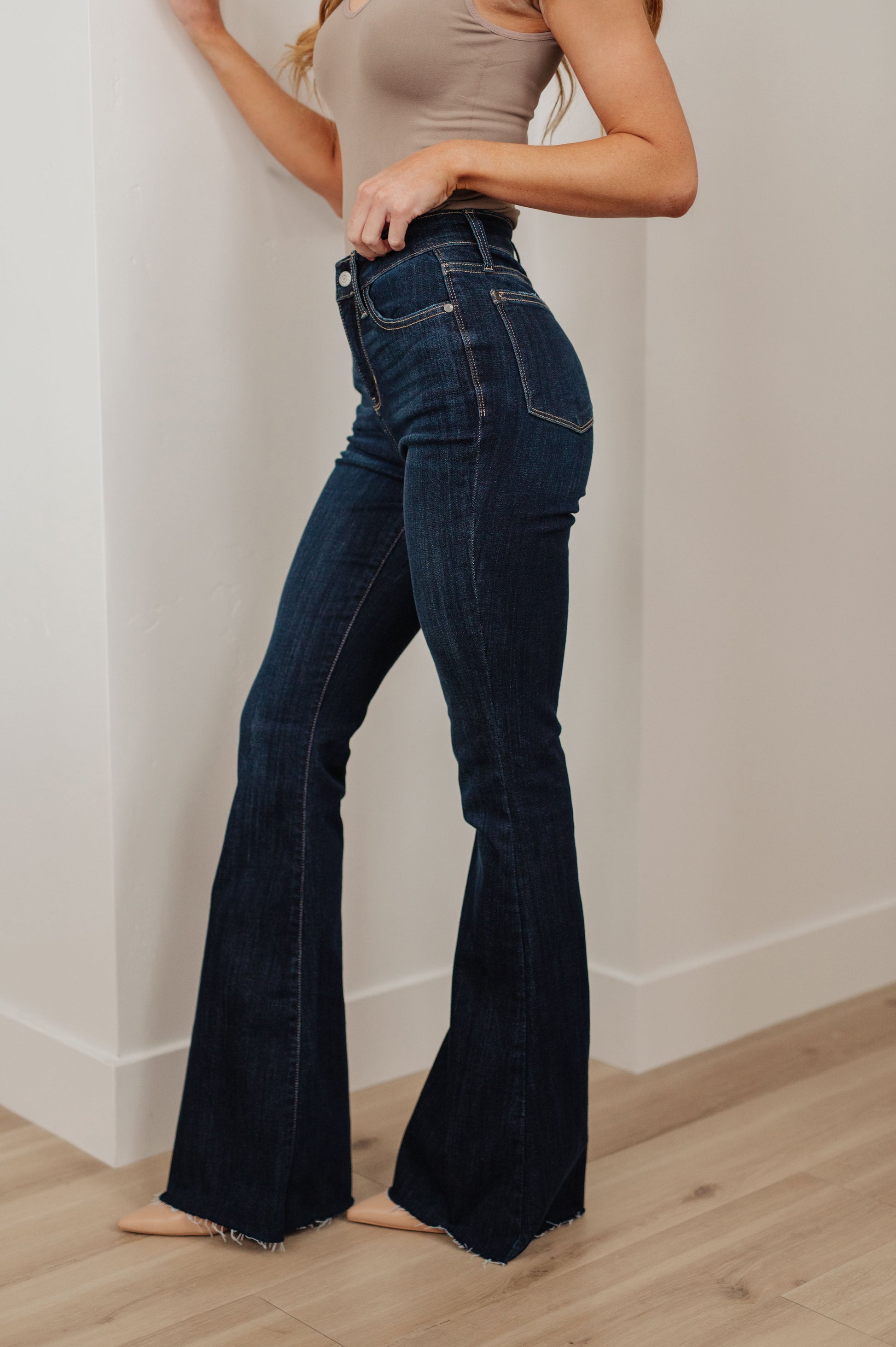 Our Jane High Rise Raw Hem Flare Jeans from Judy Blue are the perfect piece for any wardrobe. The high-rise design offers increased coverage, while the dark wash, classic flared silhouette and raw hem provide a timeless and effortless look. A great addition to any outfit. 0 -24W