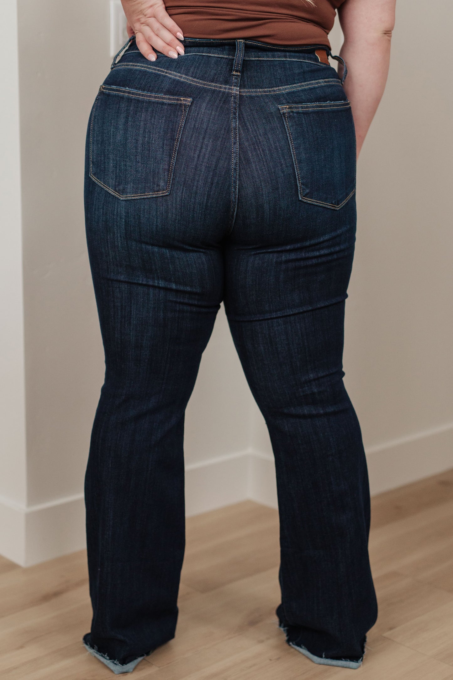 Our Jane High Rise Raw Hem Flare Jeans from Judy Blue are the perfect piece for any wardrobe. The high-rise design offers increased coverage, while the dark wash, classic flared silhouette and raw hem provide a timeless and effortless look. A great addition to any outfit. 0 - 24W