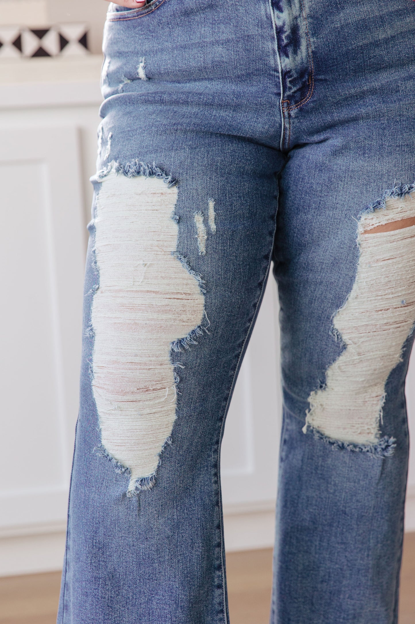 If you've got a flair for the dramatic, look no further than the Kiana Heavy Destroy Flare Jeans from Judy Blue! These amazing jeans feature a stretchy medium wash denim, that shapes a hi-rise with a five pocket cut, and zipper fly that drops into a heavy distressed leg with a raw flare hem. Pair these amazing jeans with a graphic tee, heeled boots, and a wide brim hat for a cute boho look!