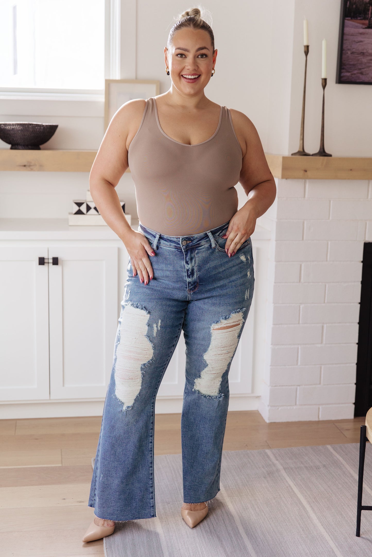 If you've got a flair for the dramatic, look no further than the Kiana Heavy Destroy Flare Jeans from Judy Blue! These amazing jeans feature a stretchy medium wash denim, that shapes a hi-rise with a five pocket cut, and zipper fly that drops into a heavy distressed leg with a raw flare hem. Pair these amazing jeans with a graphic tee, heeled boots, and a wide brim hat for a cute boho look!