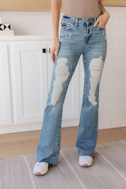 If you've got a flair for the dramatic, look no further than the Kiana Heavy Destroy Flare Jeans from Judy Blue! These amazing jeans feature a stretchy medium wash denim, that shapes a hi-rise with a five pocket cut, and zipper fly that drops into a heavy distressed leg with a raw flare hem. Pair these amazing jeans with a graphic tee, heeled boots, and a wide brim hat for a cute boho look!