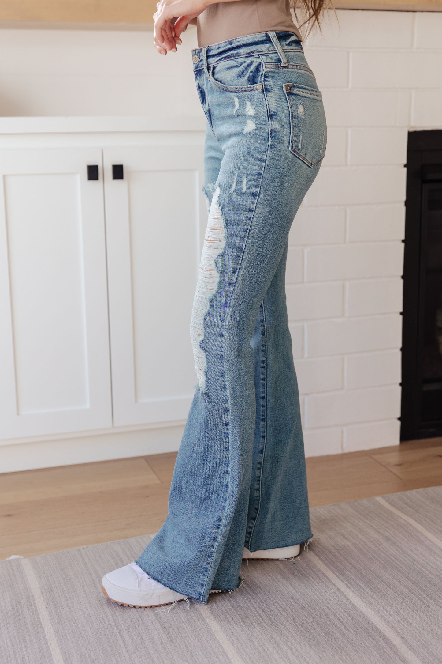 If you've got a flair for the dramatic, look no further than the Kiana Heavy Destroy Flare Jeans from Judy Blue! These amazing jeans feature a stretchy medium wash denim, that shapes a hi-rise with a five pocket cut, and zipper fly that drops into a heavy distressed leg with a raw flare hem. Pair these amazing jeans with a graphic tee, heeled boots, and a wide brim hat for a cute boho look!