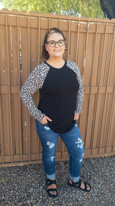 Who says you can’t look fabulous while being comfy! This black long sleeve top with leopard sleeves, features a round neckline and hemline. It is a buttery soft material. Pair with your favorite denim jeans or leggings. Don’t be afraid to get creative!