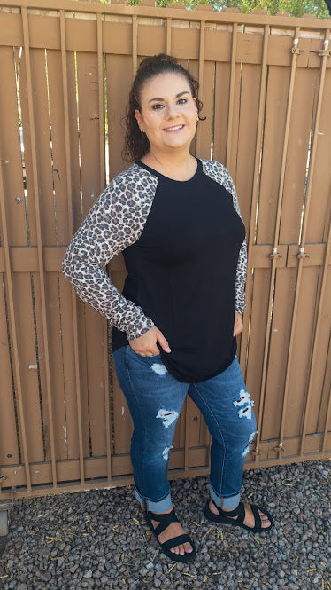 Who says you can’t look fabulous while being comfy! This black long sleeve top with leopard sleeves, features a round neckline and hemline. It is a buttery soft material. Pair with your favorite denim jeans or leggings. Don’t be afraid to get creative!