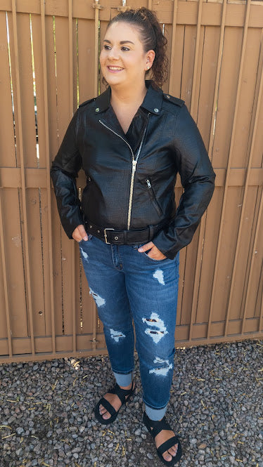 Feel trendy and edgy in this black embossed snake print jacket. This jacket features vegan leather, adjustable and removable waist belt, asymmetrical front zipper, shoulder epaulettes, front zipper pockets, long sleeves with zipper cuffs. Don’t be afraid to get creative! Sizes small through x-large.