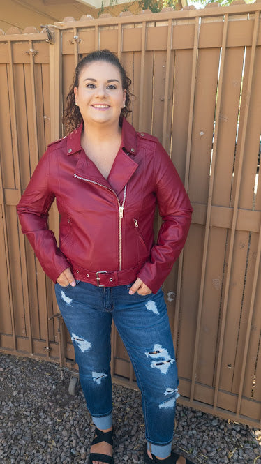 Feel trendy and edgy in this brick red jacket. This jacket features vegan leather, adjustable and removable waist belt, asymmetrical front zipper, shoulder epaulettes, front zipper pockets, long sleeves with zipper cuffs. Don’t be afraid to get creative! Sizes small through x-large.