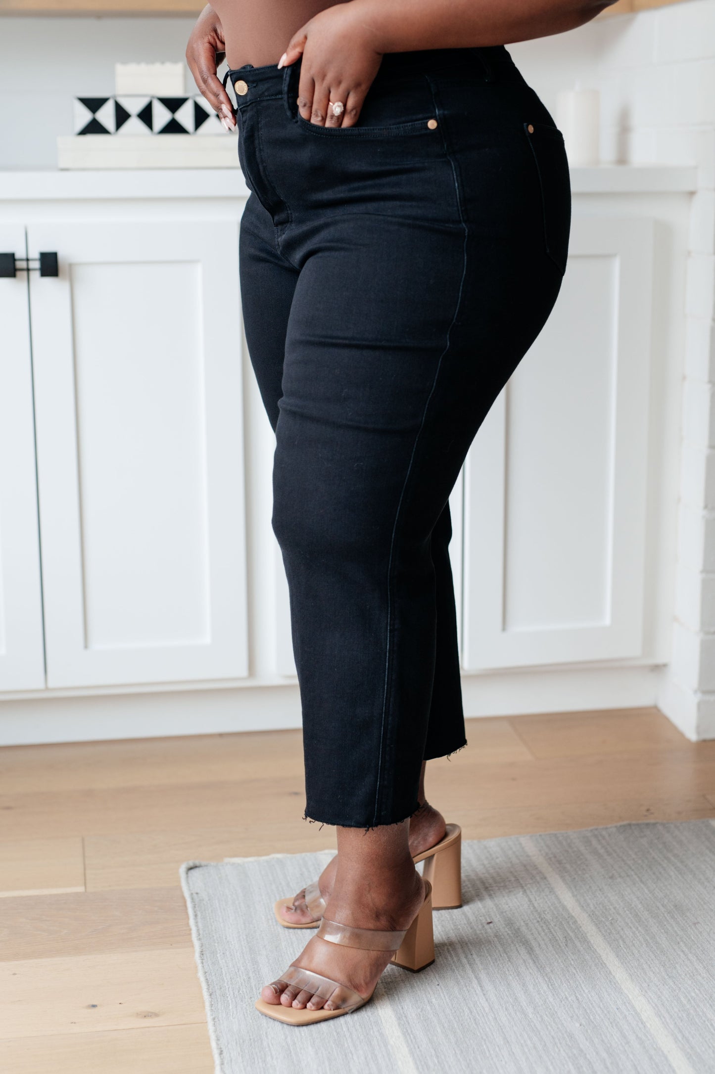 Enjoy a sleek, slimming silhouette with the Lizzy High Rise Control Top Wide Leg Crop Jeans from Judy Blue. This stylish pair features a modern high rise with tummy control technology for a comfortable, flattering fit. The wide leg cut and raw hem add a cool, modern style, while the rich black hue looks great with any top. 0 -24 W