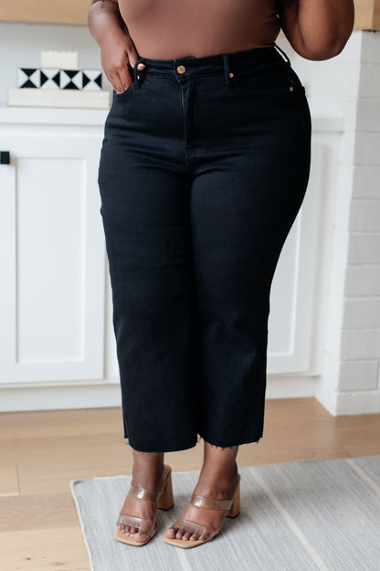 Enjoy a sleek, slimming silhouette with the Lizzy High Rise Control Top Wide Leg Crop Jeans from Judy Blue. This stylish pair features a modern high rise with tummy control technology for a comfortable, flattering fit. The wide leg cut and raw hem add a cool, modern style, while the rich black hue looks great with any top. 0 -24W