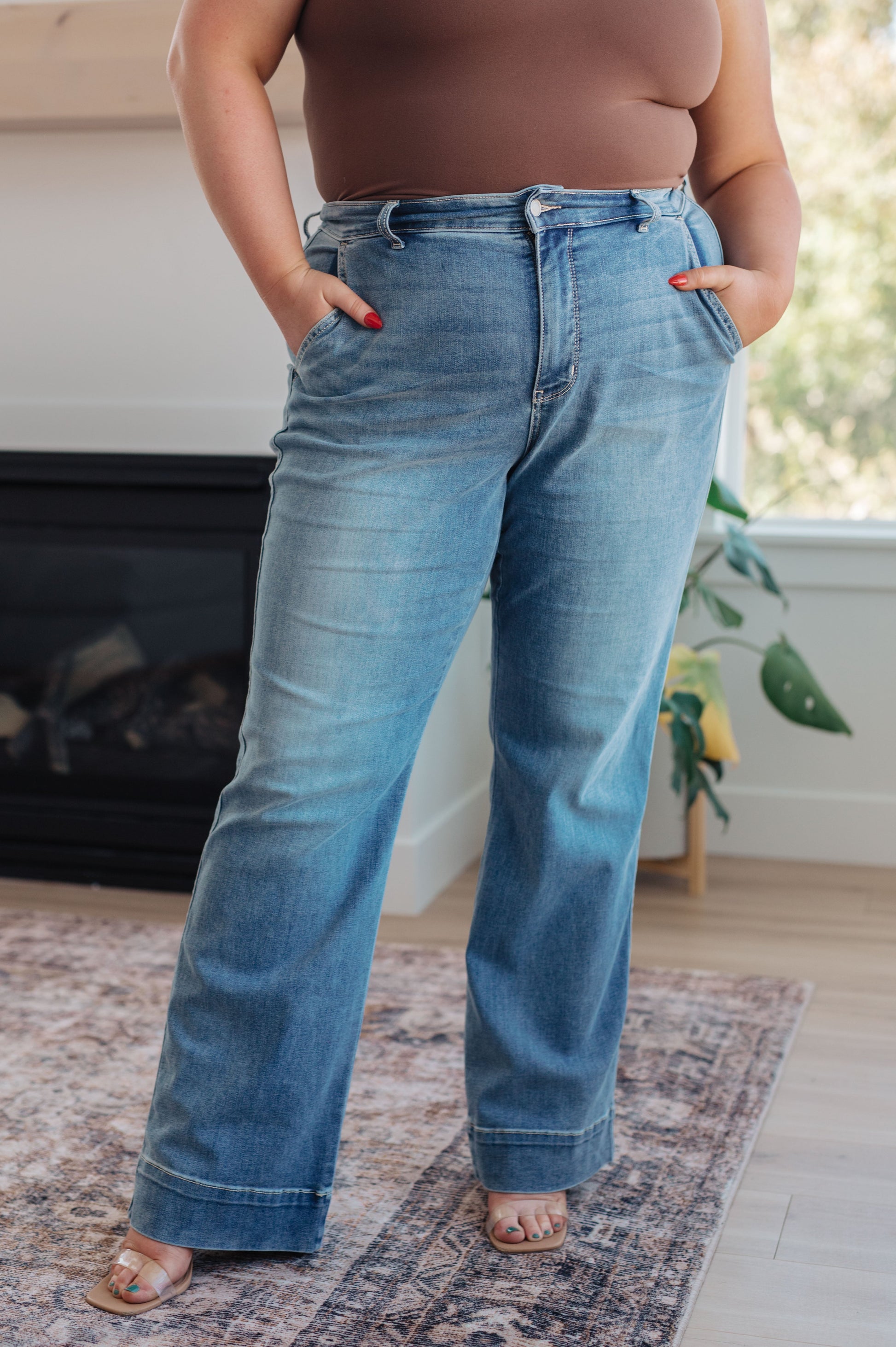 The Mindy Mid Rise Wide Leg Jeans are the perfect closet essential that can be worn year round! Featuring a stretchy light wash denim that shapes a mid rise waist with slanted pockets and zipper fly. Wide cut pant legs end at a wide hem detail and is perfected with lived-in fading throughout.  The acid wash process used to manufacture these amazing jeans may cause a variation in coloring from pair to pair! 0 - 24W