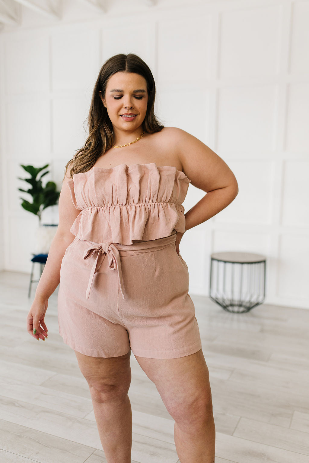 Let the Pink Skies Romper take you from day to night in style! This amazing strapless piece has adorable details like the ruffle pleated bust, tie waist, side pockets and shorts! Pair this with heels and a blazer for a daytime look then strip the blazer for date night! S - 3X