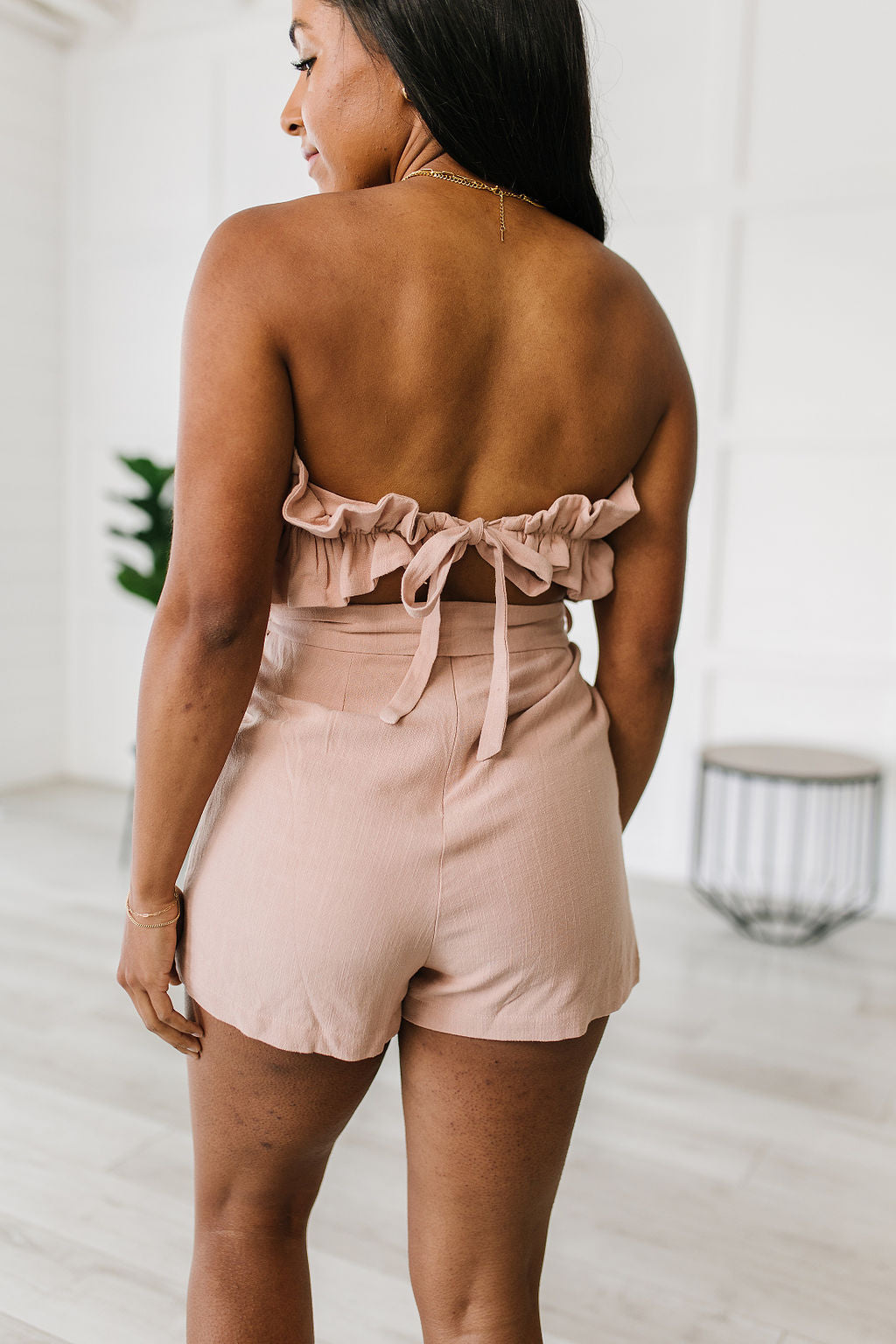 Let the Pink Skies Romper take you from day to night in style! This amazing strapless piece has adorable details like the ruffle pleated bust, tie waist, side pockets and shorts! Pair this with heels and a blazer for a daytime look then strip the blazer for date night! S -  3X