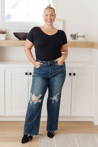 Your best outfits start with the Rose High Rise 90's Straight Jeans! Featuring a stretchy, dark wash denim that shapes a high rise waist with five pocket cut and zipper fly. 90's Straight cut pant legs end with chewed hems with distressing at the knees. 0-24-24W