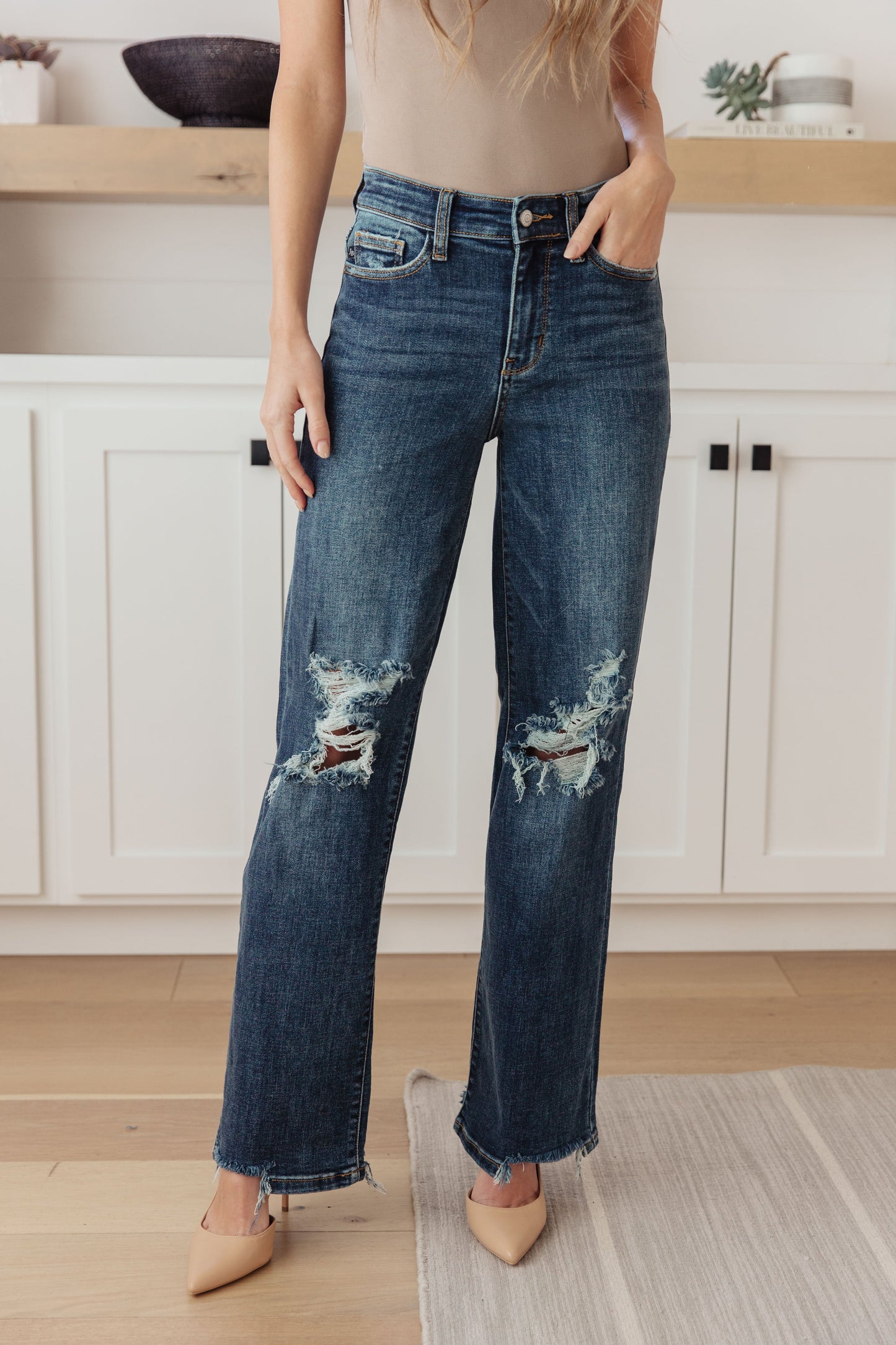 Your best outfits start with the Rose High Rise 90's Straight Jeans! Featuring a stretchy, dark wash denim that shapes a high rise waist with five pocket cut and zipper fly. 90's Straight cut pant legs end with chewed hems with distressing at the knees. 0-24-24W