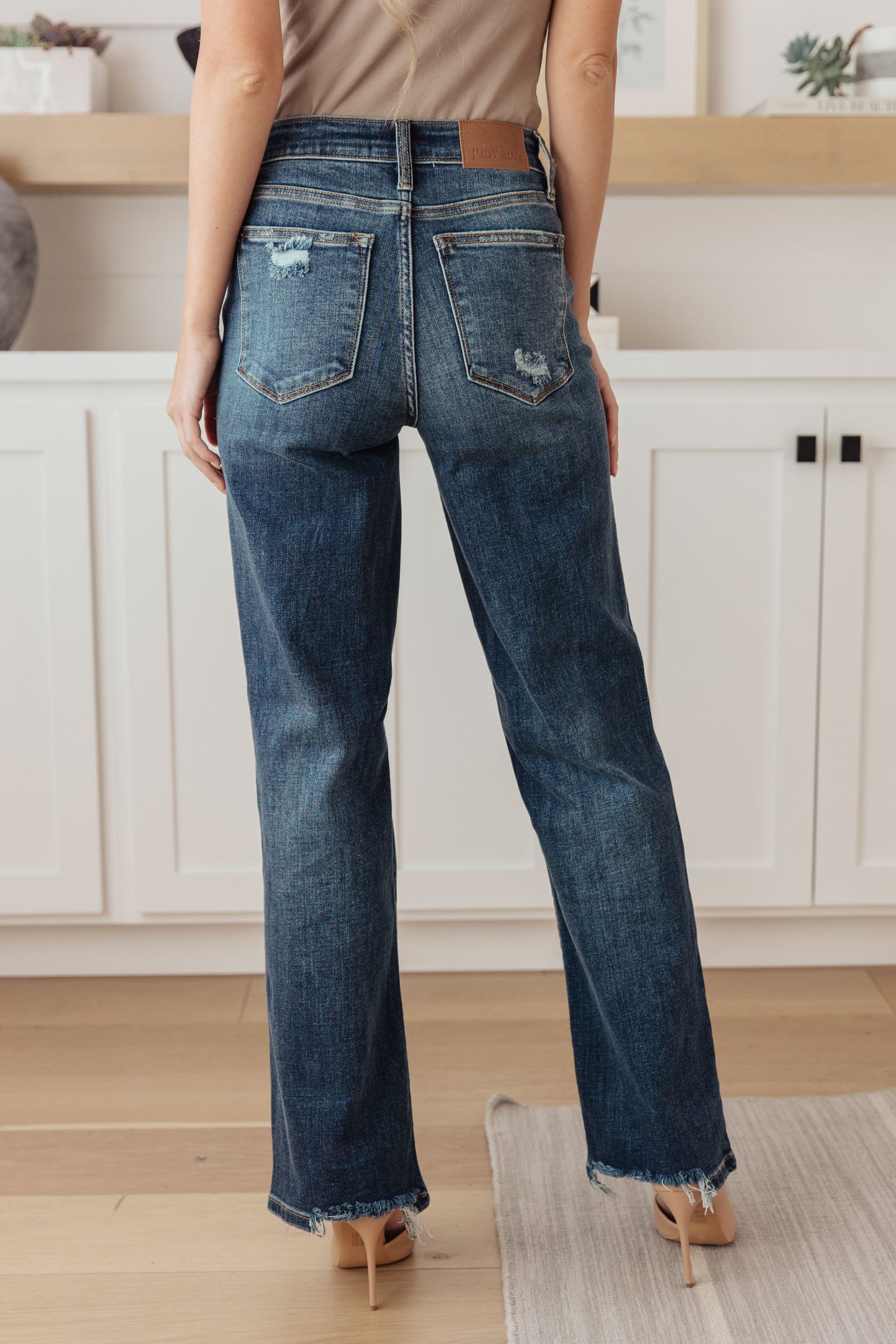 Your best outfits start with the Rose High Rise 90's Straight Jeans! Featuring a stretchy, dark wash denim that shapes a high rise waist with five pocket cut and zipper fly. 90's Straight cut pant legs end with chewed hems with distressing at the knees. 0-24-24W