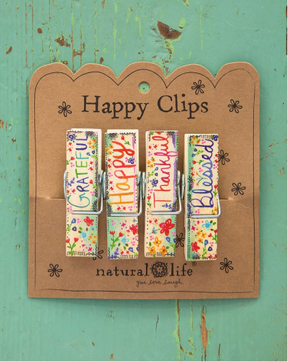 "Grateful"  "Happy"  "Thankful"  "Blessed"  Keep this set of four super-cute Bag Clips from Natural Life handy around the kitchen to help add a bright touch to the room! Use them on open bags to keep food fresh and more. After all, any pantry could use an extra touch of boho flair.  Set of 4 Happy Clips Wood material Each clip measures 2.75"L x 0.75"W x 0.625"H