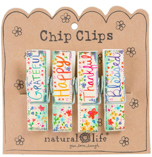 "Grateful"  "Happy"  "Thankful"  "Blessed"  Keep this set of four super-cute Bag Clips from Natural Life handy around the kitchen to help add a bright touch to the room! Use them on open bags to keep food fresh and more. After all, any pantry could use an extra touch of boho flair.  Set of 4 Happy Clips Wood material Each clip measures 2.75"L x 0.75"W x 0.625"H