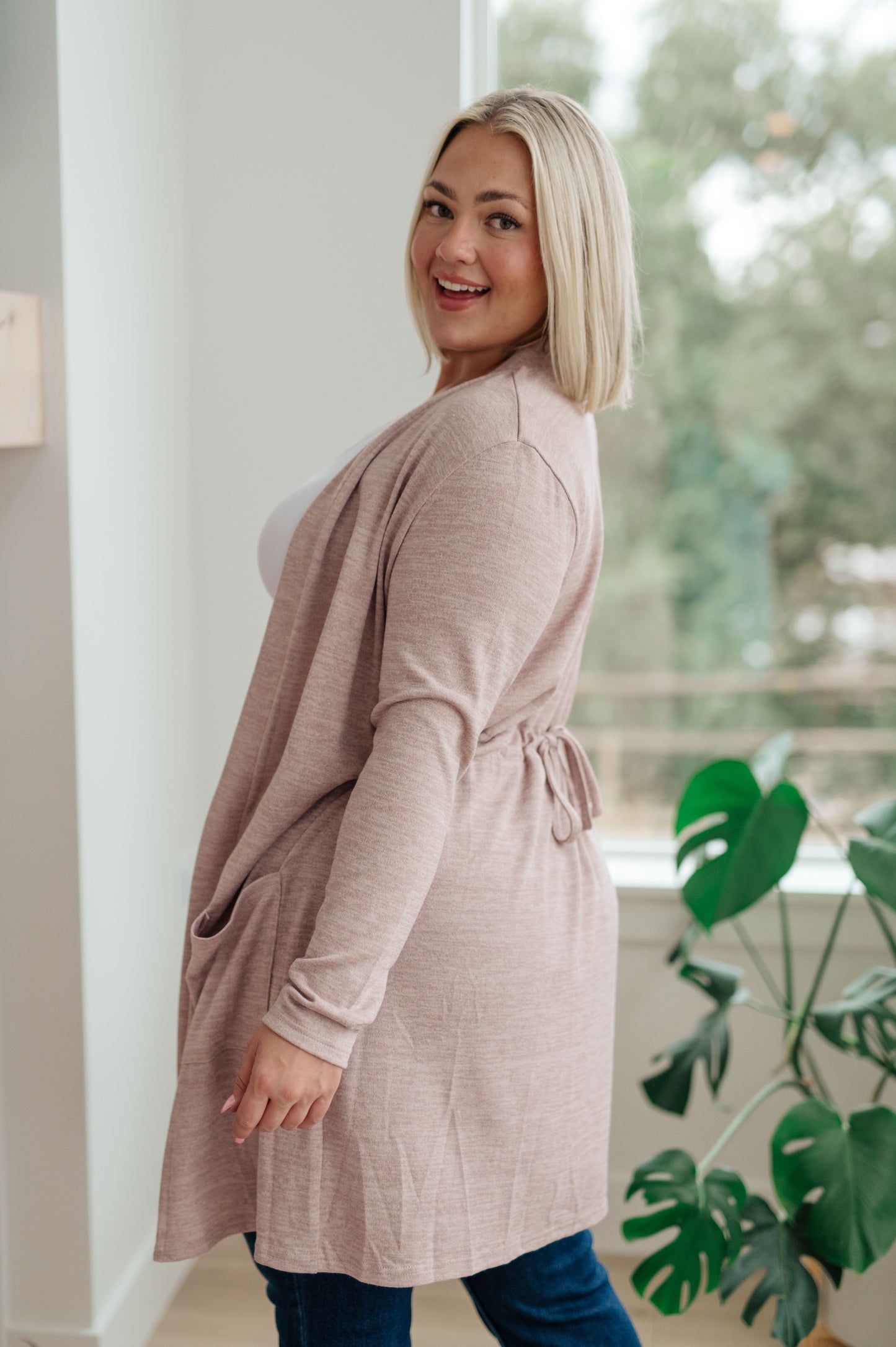 Our Staying Hopeful Cardigan is the perfect lightweight layer to add to your wardrobe. It features a sweater knit construction and an open front, with a drawstring in the back to cinch the waist for a more flattering shape. Perfect for cool days and evenings.
