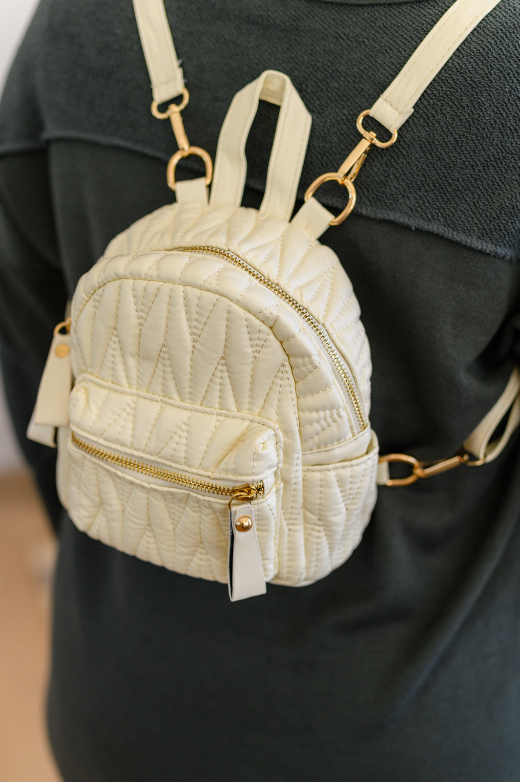 Introducing the Take It With You Quilted Mini Backpack - the perfect accessory for those who want to carry their essentials in style. This mini backpack features soft quilted PU leather with luxurious gold accents, adding a touch of elegance to any outfit. With its convenient zipper closure and adjustable straps, it offers both style and functionality. Whether you're heading out for a day of adventure or a night on the town, the Take It With You Quilted Mini Backpack is sure to be your go-to companion.