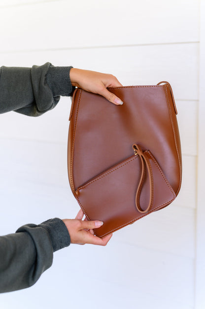 The Take the Best Shoulder Bag is the perfect accessory for the modern go-getter. Crafted from faux leather, its scoop shaped tote design is paired with a sleek, matching zippered pocket with wristlet, and adjustable strap for maximum comfort. Upgrade your style today!
