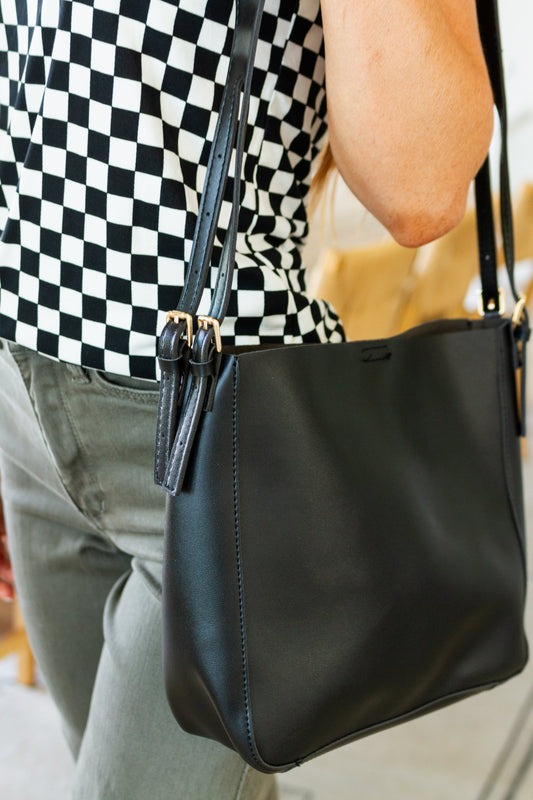 The Timeless Carry Tote Bag is the perfect bag for the fashion-forward jetsetter. Crafted from high-quality vegan leather, it features a shoulder tote, zipper pocket, and magnetic closure that make it easy and comfortable to carry. Chic and versatile, you'll make a statement no matter where you go!