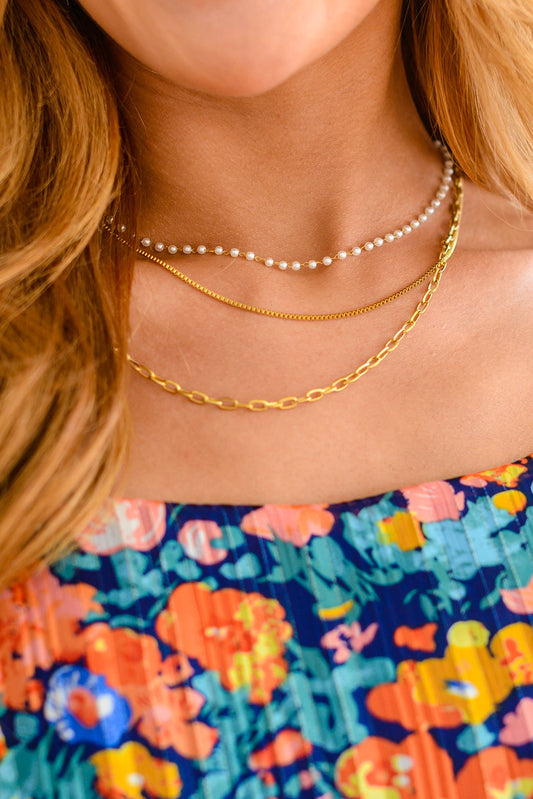 Discover the ultimate accessory with our Triple Threat Layered Necklace. This masterpiece of three 18K gold chains, each with a unique style and stunning accents, will take your look to the next level. Featuring three connected chains: a pearl accented chain, a box chain, and a paperclip chain, layered at different lengths. Perfect for special occasions yet simple enough for everyday wear, this piece is sure to be your new favorite.