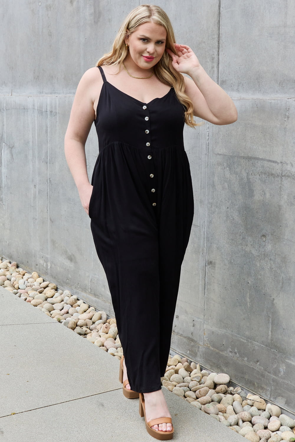 This jumpsuit is designed to be your go-to outfit for any occasion, whether you're running errands, attending a casual gathering, or simply lounging at home. This jumpsuit features a wide leg silhouette that not only offers a chic and contemporary look but also allows for unrestricted movement.