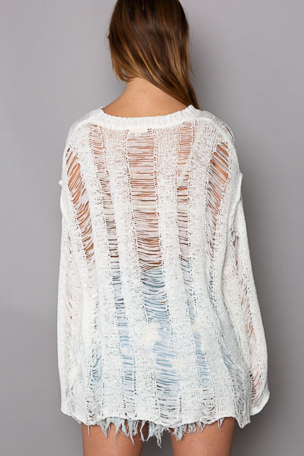 This Distressed Round Neck Long Sleeve Knit Cover Up is a stylish and versatile piece for your wardrobe. The distressed knit detailing adds a trendy and edgy touch to the classic round neck design. S - L