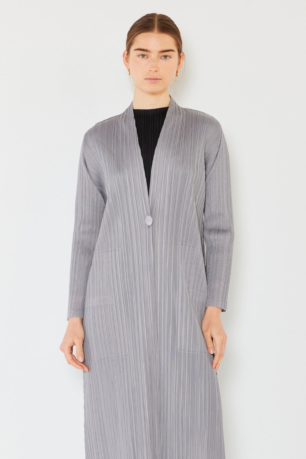The Pleated Long Sleeve Cardigan is a versatile and chic layering piece for your wardrobe. With its pleated detailing and long sleeves, this cardigan offers a stylish and sophisticated look. The pleats add texture and visual interest to the classic cardigan design. 