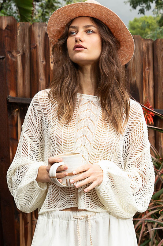 The Openwork Balloon Sleeve Knit Cover Up is a chic addition to any wardrobe. The intricate openwork detailing on the sleeves adds a touch of elegance and sophistication to this knit cover up.  S - L