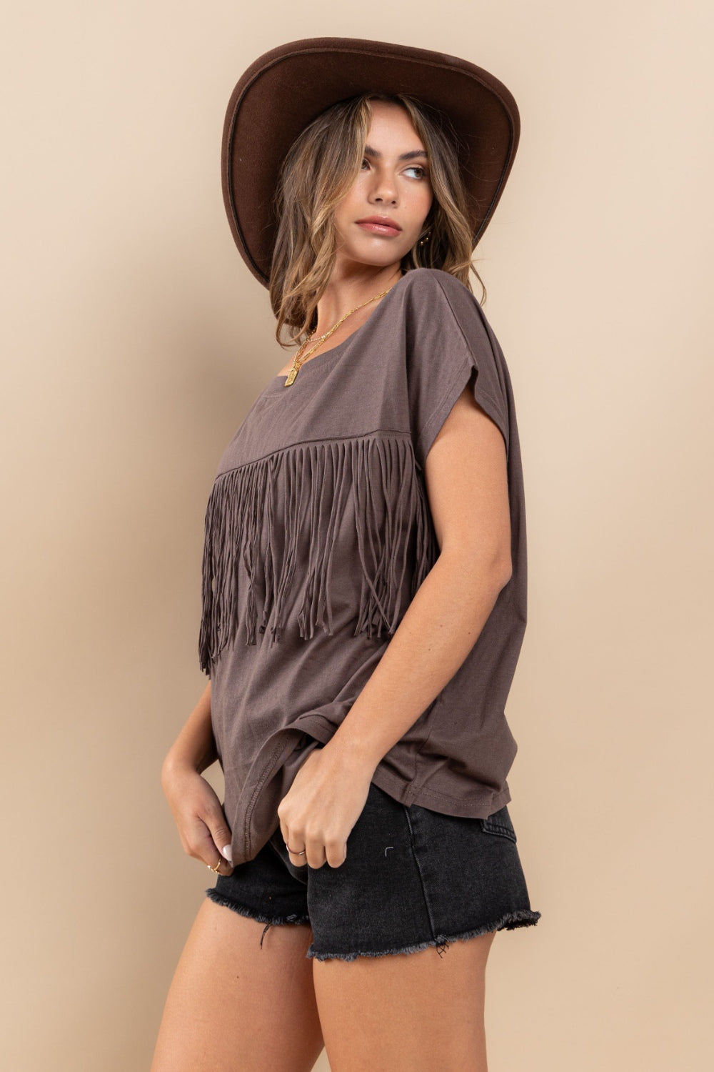 The Fringe Detail Round Neck Short Sleeve Top is a trendy and stylish addition to any wardrobe. The fringe detailing adds a fun and playful touch to this classic silhouette S - L