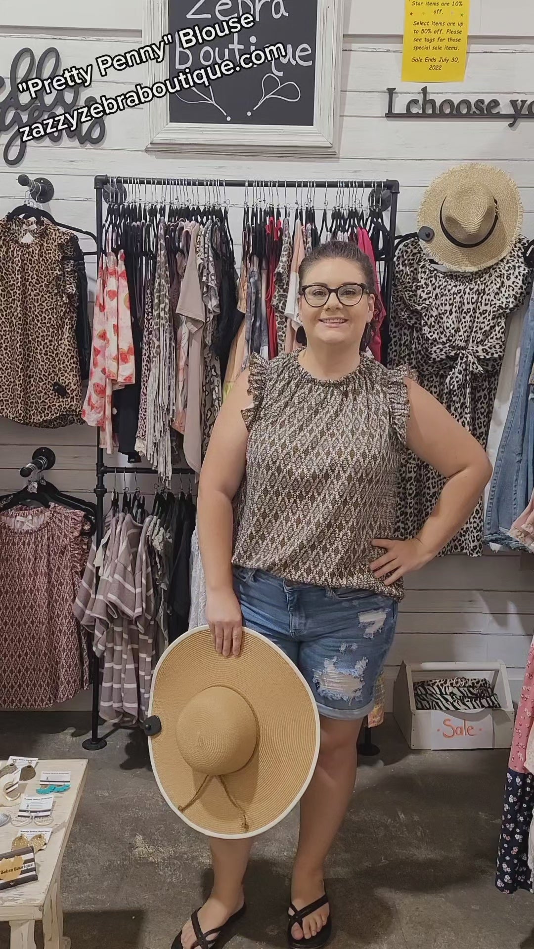 “Pretty Penny” is a patterned sleeveless blouse featuring a rounded hemline, a ruffled elastic neckline and ruffled sleeves. It is a waffle knit, relaxed fit. This is unlined, non-sheer, and lightweight. The colors are camel, white and black. Sizes small through large.