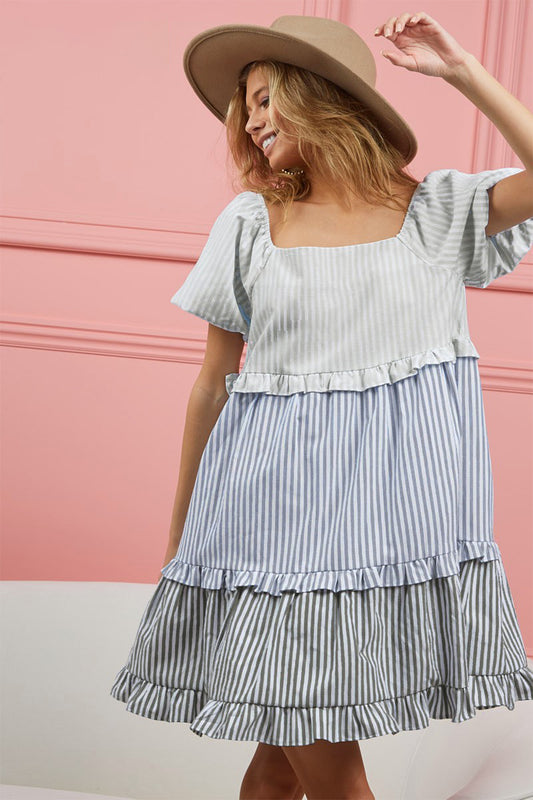 The Striped Ruffle Tiered Mini Dress is a playful and feminine choice for a stylish and flirty look. With its striped pattern and ruffle tiered design, this dress exudes a fun and whimsical vibe. The mini length adds a hint of flirtiness, perfect for a chic outfit.